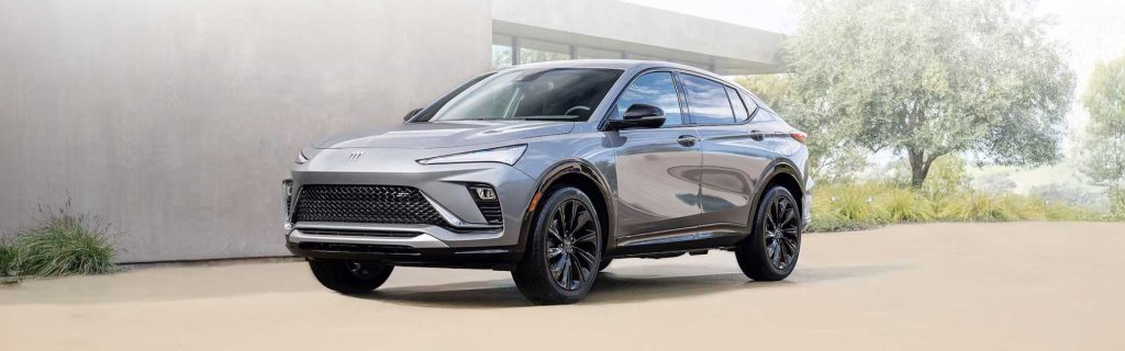 2025 Buick Envista silver color parked in front of a house